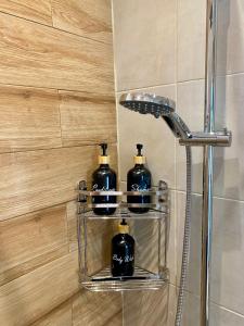 a bathroom with two bottles of soap on a shelf at Oliva - 1 bedroom apartment in Benitses