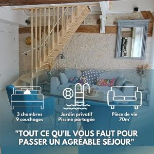 a living room with a blue couch and a staircase at Gîte La Grange 9 pers in Saint-Georges-sur-Cher