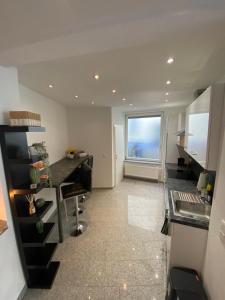 a kitchen with a counter and a large window at Apartment Kompakt Gottschalk in Kassel