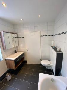 a bathroom with a sink and a toilet and a sink at Apartment Kompakt Gottschalk in Kassel