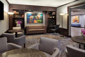 a lobby with a couch and a tv and tables at InterContinental Toronto Centre by IHG in Toronto