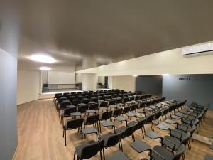 an empty lecture hall with chairs and a podium at Hotel Samara with Relax area in Balchik