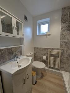 a bathroom with a sink and a toilet at Stylish York Studio in York