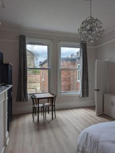 a bedroom with a bed and a table and two chairs at Studio flat in York in York