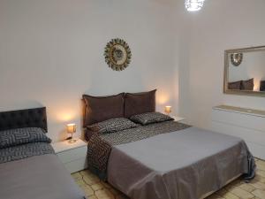A bed or beds in a room at Vallese Holiday Home Apartment Maiori