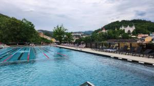 een groot zwembad met stoelen bij Centrum Karlovy Vary Divadelní in Karlsbad