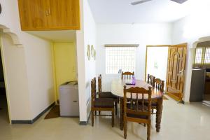 a kitchen and dining room with a table and chairs at Izi Transit Stay in Chennai