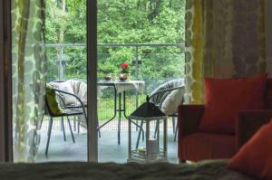 a living room with a table and chairs and a window at Apartament Inez in Kołobrzeg