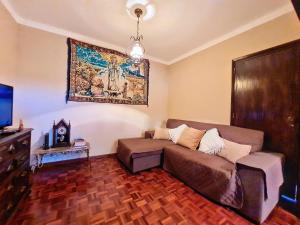 a living room with a couch and a painting on the wall at Cantinho da Lourdes e Tonito Nº 136193/AL in Miro