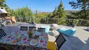 a patio with a table and chairs with a view at Villa YOLO in Almyrida