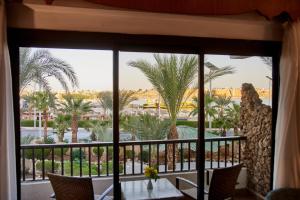 een raam met uitzicht op een resort met palmbomen bij Turquoise Beach Hotel in Sharm El Sheikh