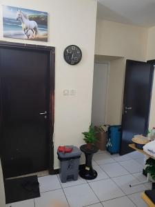 a room with a black door and a clock on a wall at Dubai Homes near ADCB METRO STATION in Dubai