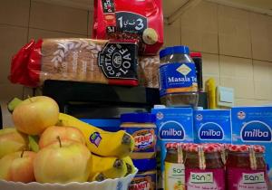 a counter with apples bananas and other food items at Dubai Homes near ADCB METRO STATION in Dubai