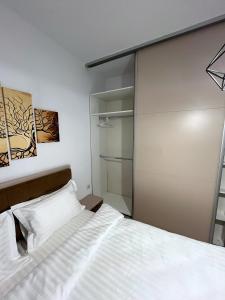 a bedroom with a bed and a glass closet at RBC Apartments with garden view in Cluj-Napoca
