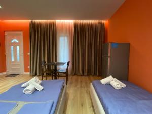 a hotel room with two beds with towels on them at Tirana Center Apartaments in Tirana