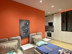 a living room with a couch and a kitchen at Tirana Center Apartaments in Tirana