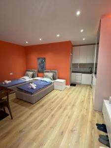 a large room with two beds and a kitchen at Tirana Center Apartaments in Tirana