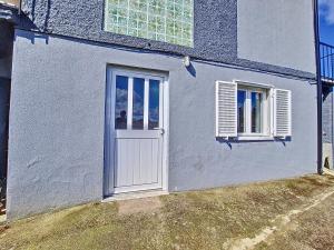 ein weißes Haus mit einer Tür und zwei Fenstern in der Unterkunft Cantinho da Lourdes e Tonito Nº 136193/AL in Miro + 90 Fotos