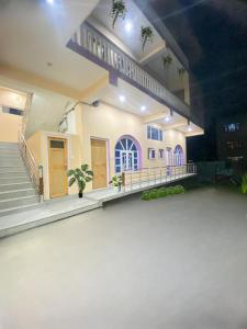 a large room with a building with stairs and a building at Pall Residency in Srinagar