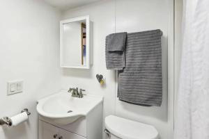 a bathroom with a sink and a toilet and a towel at Cabin 9 - Toronto Lake- Fishing, Swimming & More! cabin in Toronto