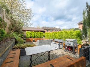a backyard with a barbecue and a grill at Lux Light Spacious- Chilterns Pass the Keys in Amersham