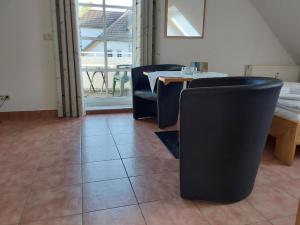 オストゼーバート・ディアーハーゲンにあるParkresidenz Dierhagenのダイニングルーム(黒い椅子、テーブル、窓付)