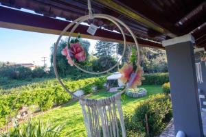 a hoop with flowers hanging from a porch at Casa di Michele in Perama