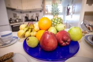 a blue plate of fruit on a kitchen counter at Casa di Michele in Perama