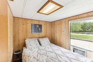 a bedroom with a bed and a window at Cabin 10- Cozy Toronto Lake Cabin - Walk to the Water cabin in Toronto +13 photos