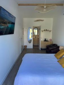 a bedroom with a large bed and a living room at Great Room 29 in Mérignac