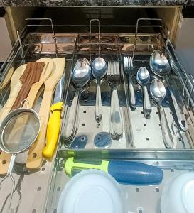 a drawer filled with utensils and utensils at Hillview 2BHK Flat in Dehradun in Dehradun