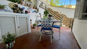 une table et des chaises sur une terrasse agrémentée de plantes dans l'établissement Casa Vacanza Trono Del Sol, à Vietri