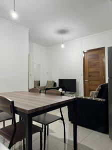 a living room with a wooden table and chairs at Comfy 2-Bedroom Apt, 10mins Walk to Beach - GBHC5 in Grand Baie