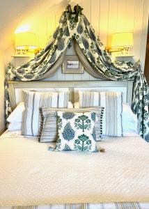 a bedroom with a bed with a headboard and pillows at The Artist Residence Dublin in Sutton