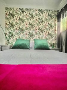 a bedroom with a large bed with a pink carpet at Teror Centro 1 in Teror