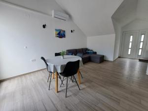 a living room with a table and a couch at Apartment Teuta in Žirje