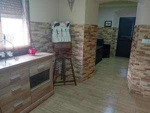 a kitchen with wooden floors and a room with a bunch of shoes at Villa Mina in Minas de Ríotinto