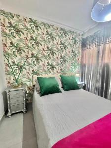 a bedroom with a large bed with a pink rug at Teror Centro 1 in Teror