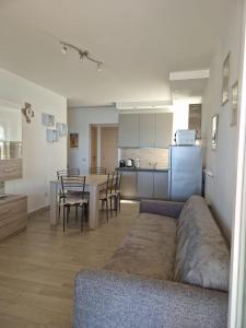 a living room and kitchen with a couch and a table at La finestra sul golfo in Ospedaletti