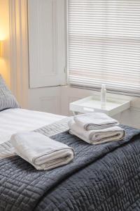 a bedroom with a bed with two towels on it at 7 Mount Sion in Royal Tunbridge Wells