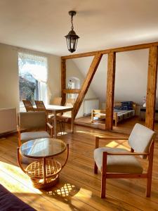 a living room with a glass table and chairs at Stara Szkoła na Warmii in Mokiny