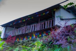 a building with colorful flags on the side of it at Nama Stay Home in Pokhara