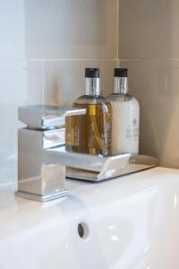 two bottles of soap sitting on top of a sink at 7 Mount Sion in Royal Tunbridge Wells