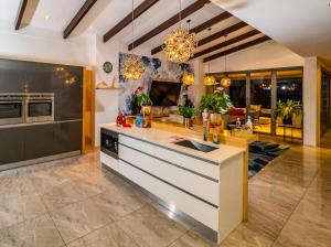 a kitchen with a large island and a living room at Lavender Dreams - Villa 111 in Hermanus