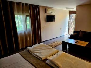 A television and/or entertainment centre at Orehite-Family Hotel ,Food & Pool
