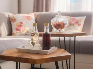 a table with two bottles and a glass bowl on it at Apartman Marin in Zagreb