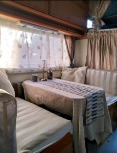 a bedroom with a bed and a couch in a room at Sweet Camper in Florence