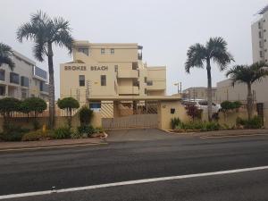 a building with a flower park sign on the side of a street at 15 BRONZE BEACH UMHLANGA ROCKS DURBAN in Durban +2 photos