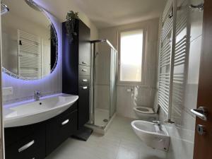 a bathroom with a sink and a shower and a toilet at Azzurro Horizon Apartment in Bellaria-Igea Marina +7 photos