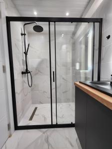 a bathroom with a shower with a glass door at District Apartment in Bitola +19 photos